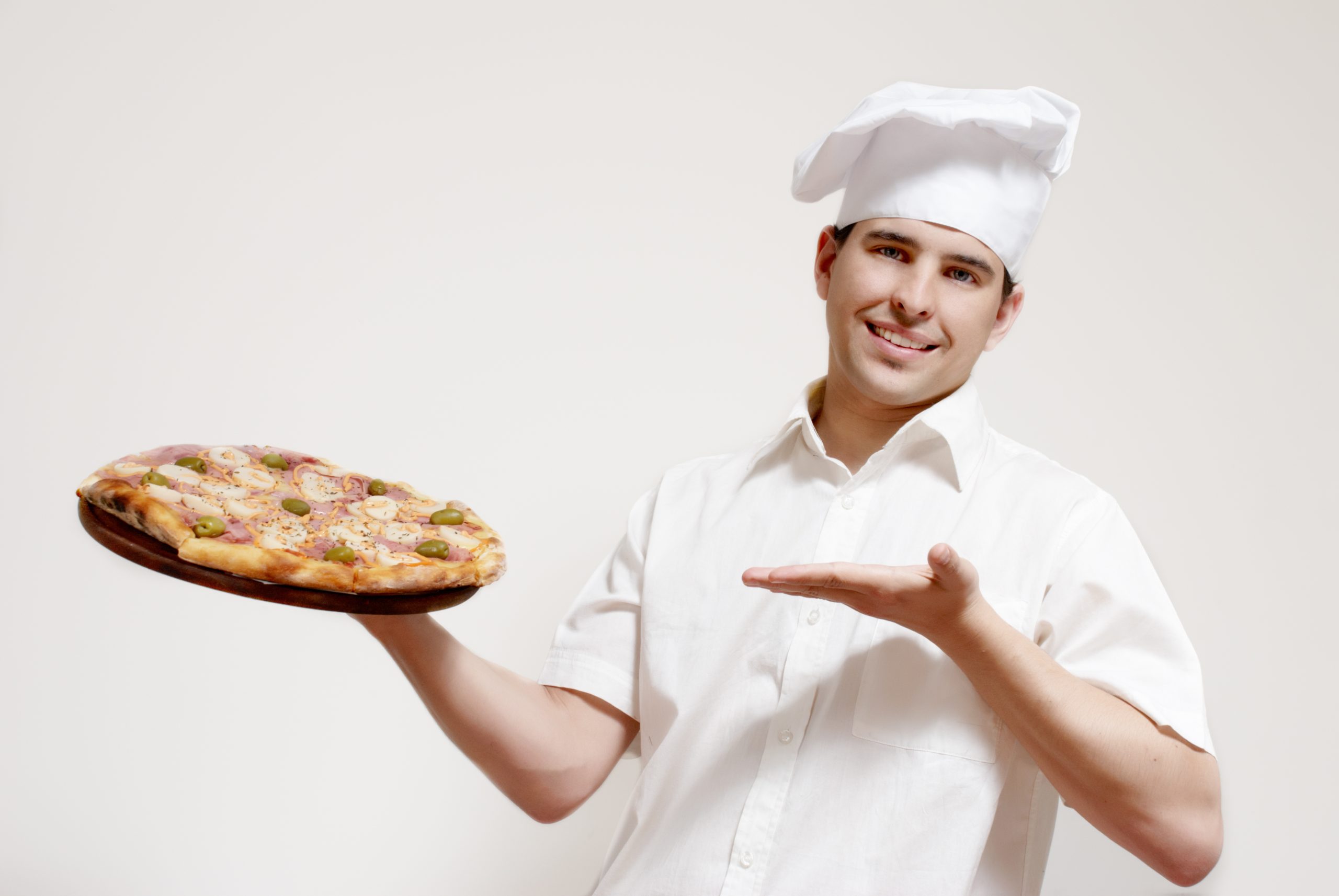 Portrait of happy attractive cook with a pizza in hands